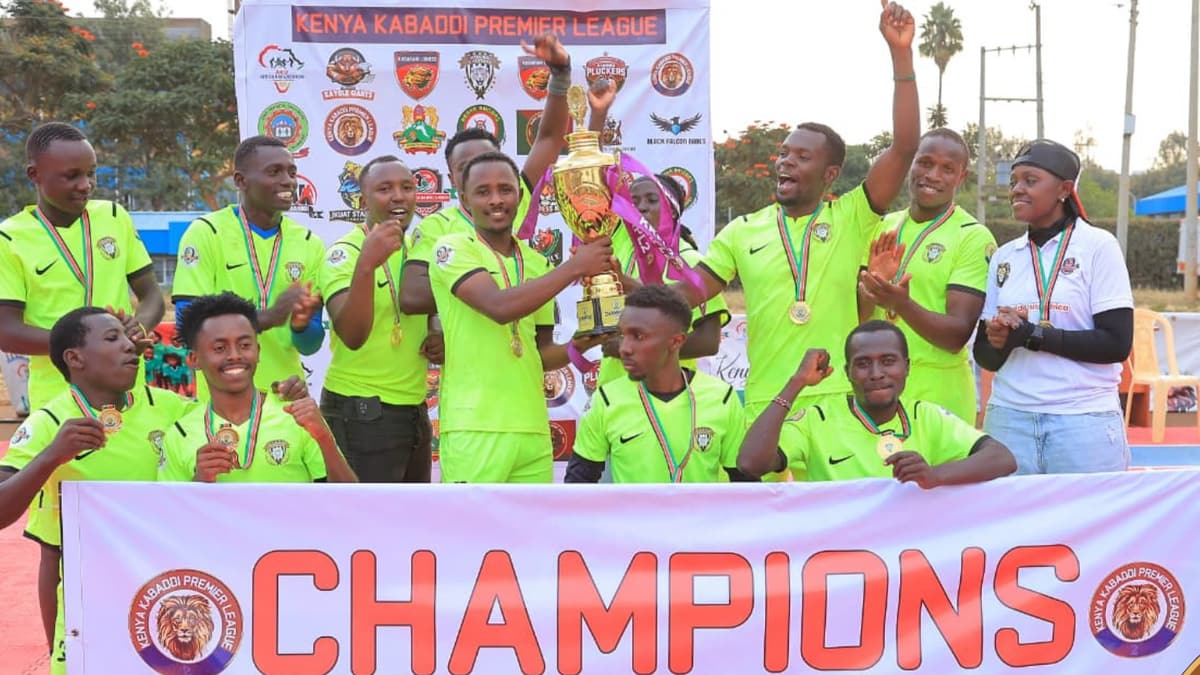 Githurai Cheetahs, in lime green, celebrate with the KKPL Season 2 trophy behind a “Champions” banner.