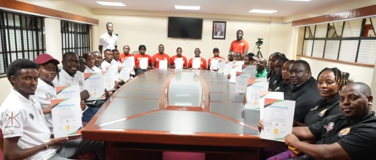 Participants in the April 2024 Level 1 umpire course around a boardroom table.