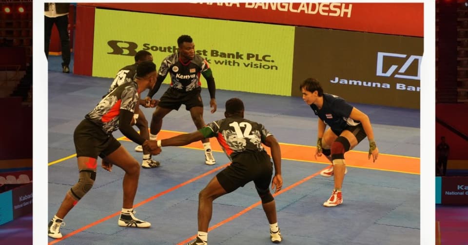 Kenya’s defenders link hands to meet a Thailand raider at the 4th Bangabandhu Cup.